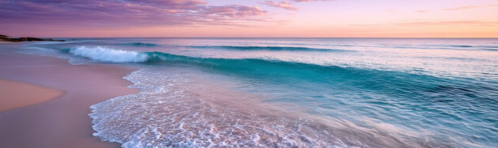 Calm ocean shoreline at sunset